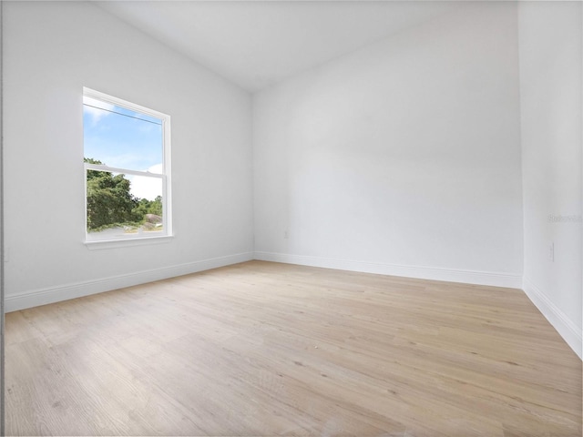 unfurnished room with light wood finished floors and baseboards