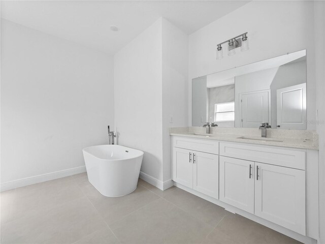 bathroom with vanity, tile patterned floors, and a tub