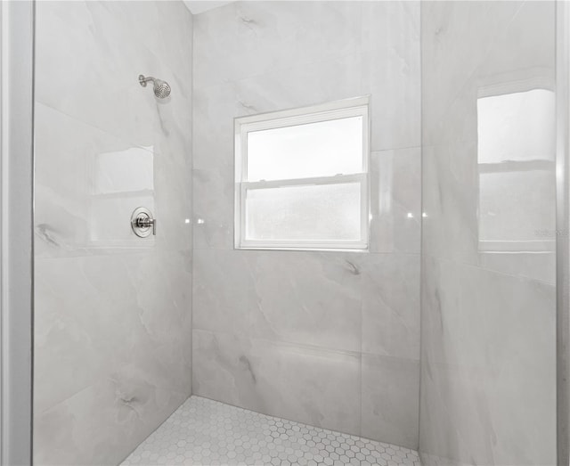 bathroom with a tile shower