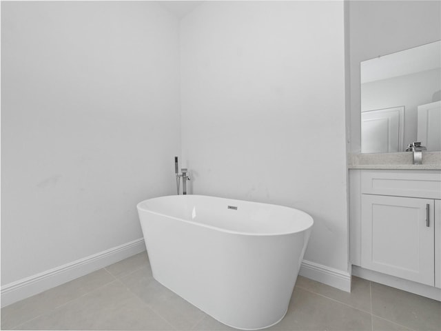 bathroom featuring vanity, a bathtub, and tile patterned floors