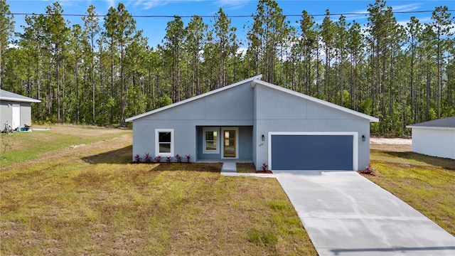 view of front of property with a garage and a front yard