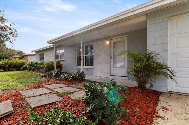 doorway to property with a garage