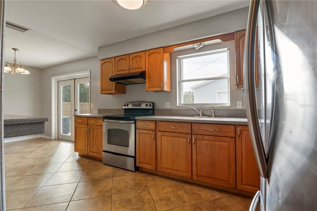 kitchen featuring decorative light fixtures, appliances with stainless steel finishes, sink, and a wealth of natural light