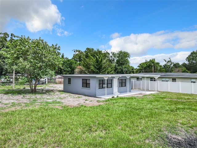 back of property featuring a lawn