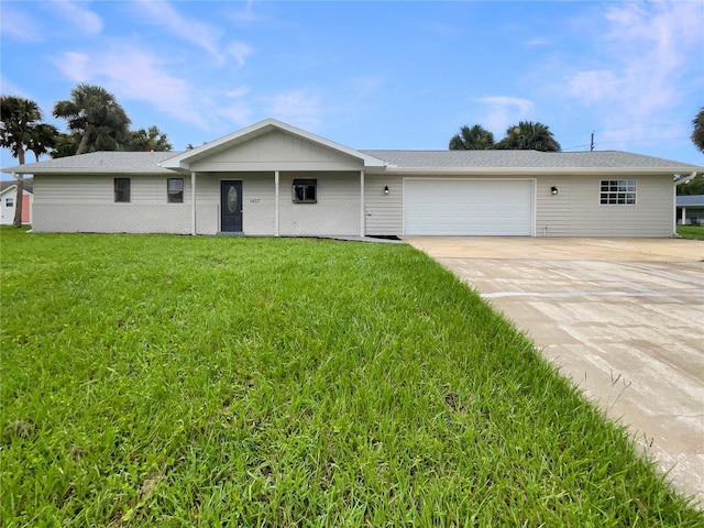 ranch-style home featuring concrete driveway, brick siding, a garage, and a front lawn