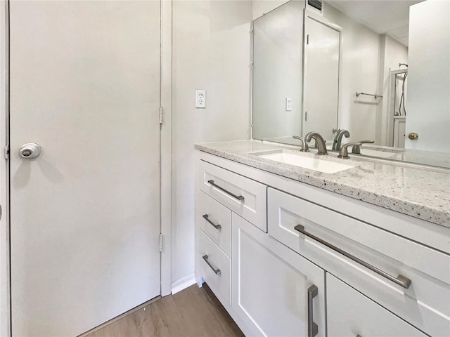 bathroom featuring vanity and wood finished floors