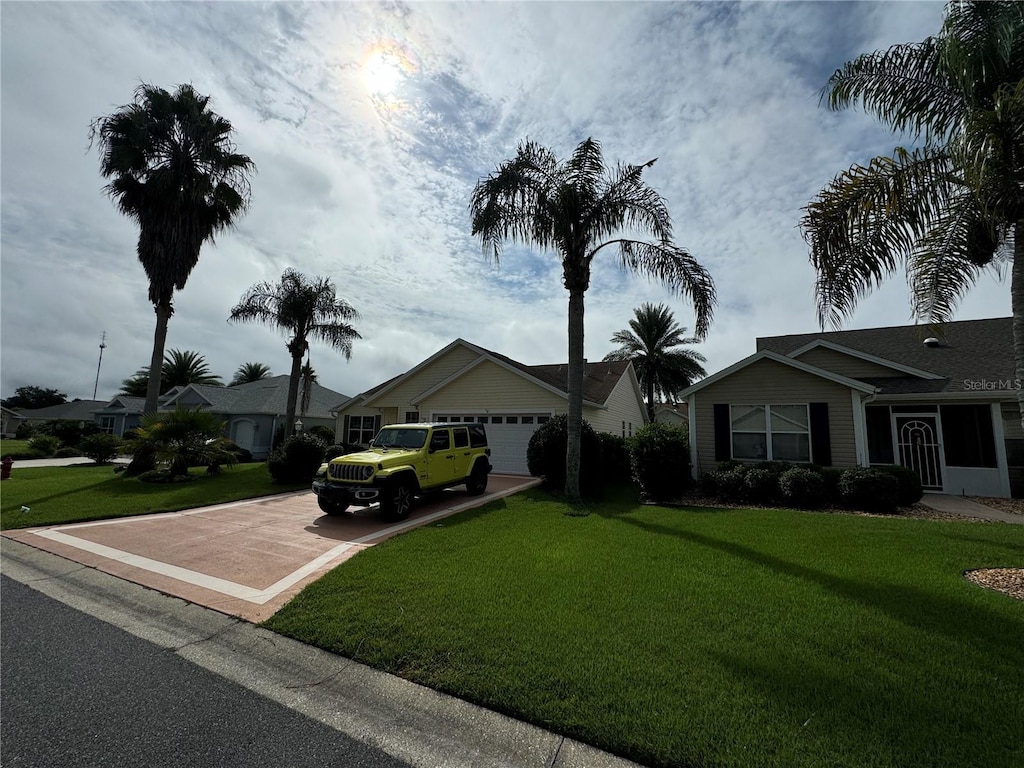 view of front of house featuring a front yard and a garage