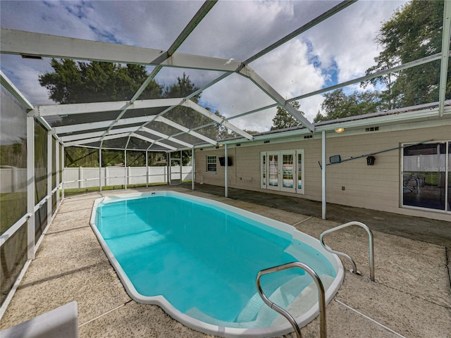 view of pool with a lanai, a patio area, and french doors