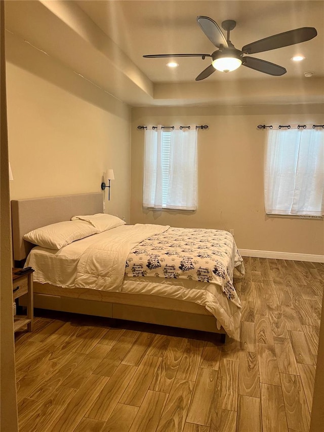 bedroom with hardwood / wood-style floors and ceiling fan