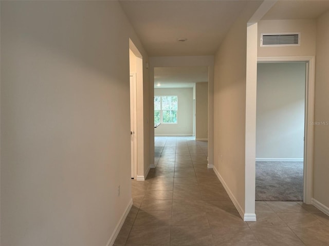 corridor with tile patterned flooring