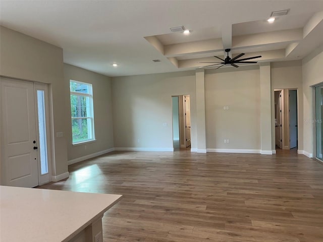 unfurnished living room featuring wood-type flooring and ceiling fan