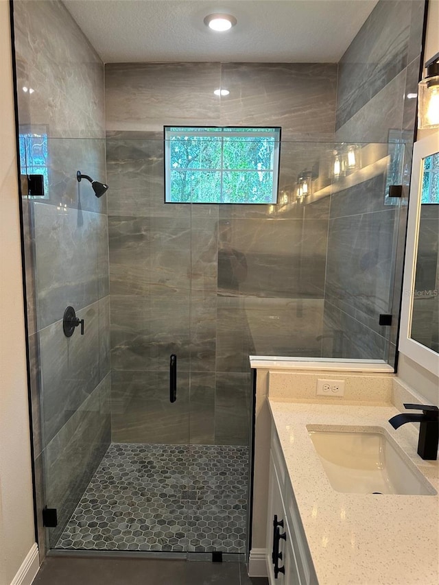 bathroom featuring vanity, an enclosed shower, and tile patterned flooring