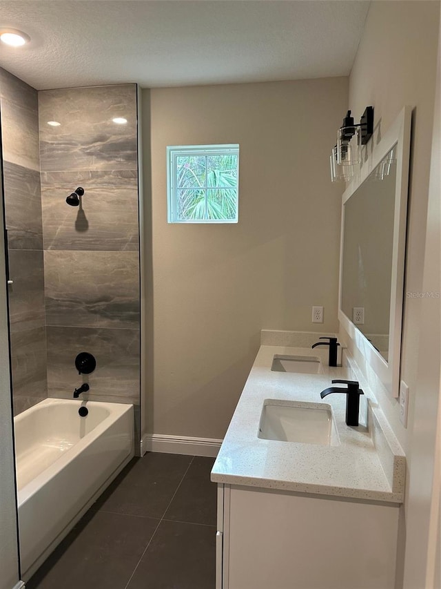 bathroom with tile patterned flooring, vanity, and tiled shower / bath combo