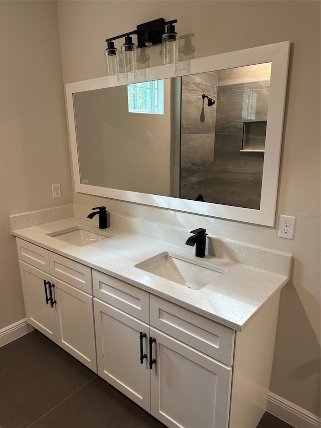 bathroom with vanity, tile patterned floors, and tiled shower