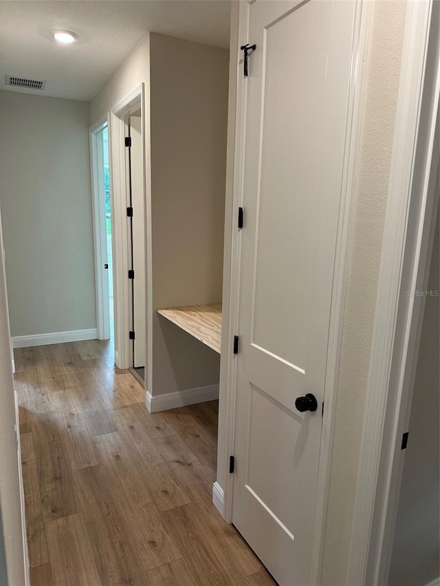 corridor featuring light hardwood / wood-style flooring