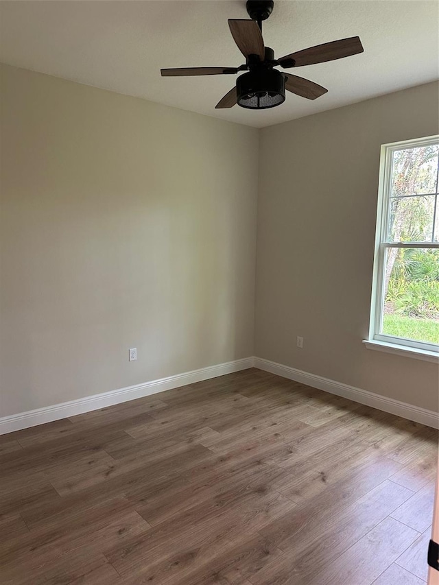 unfurnished room featuring hardwood / wood-style flooring and ceiling fan