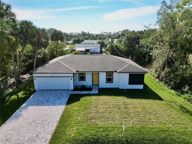 single story home with a garage and a front lawn