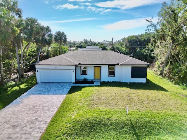 ranch-style house with a garage and a front lawn