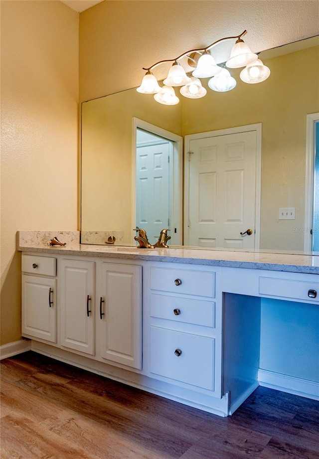 bathroom with hardwood / wood-style floors and vanity