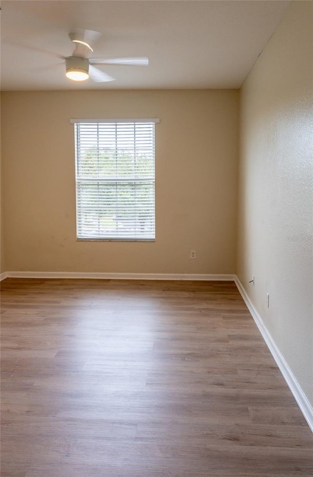 spare room with light hardwood / wood-style flooring and ceiling fan