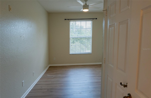 unfurnished room with hardwood / wood-style floors and ceiling fan