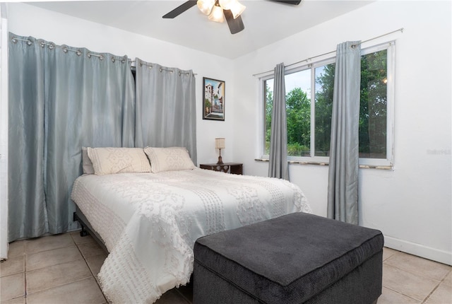 tiled bedroom featuring ceiling fan