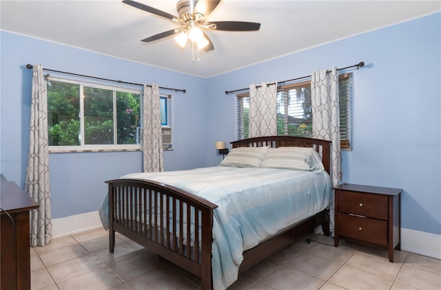 bedroom with multiple windows, light tile patterned floors, and ceiling fan