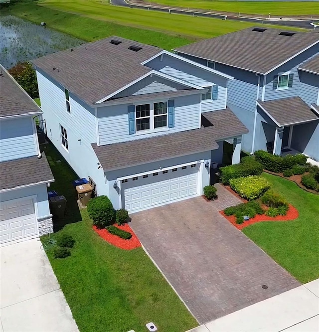 view of front of home with a garage and a front yard