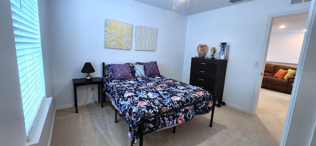 bedroom with carpet and multiple windows