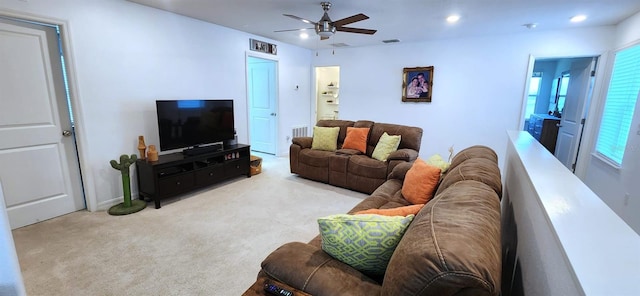 carpeted living room featuring ceiling fan