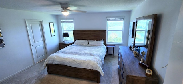 carpeted bedroom with a textured ceiling and ceiling fan