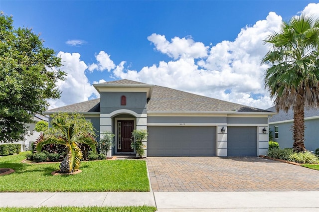 view of front facade with a garage and a front lawn