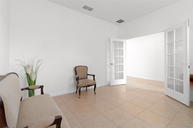 sitting room featuring light tile patterned flooring and french doors