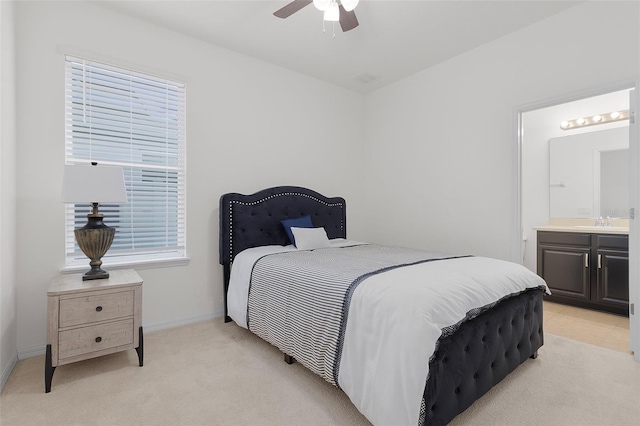 bedroom featuring ensuite bath, ceiling fan, light colored carpet, and multiple windows