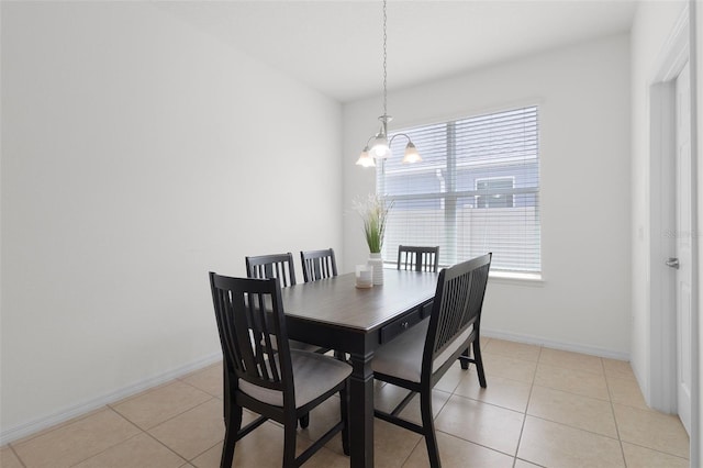 dining area with a notable chandelier and light tile patterned floors