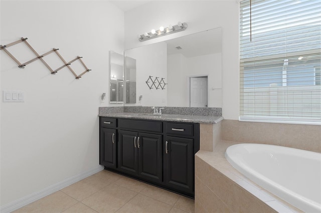 bathroom with vanity, a relaxing tiled tub, and tile patterned floors