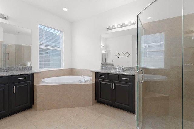 bathroom with tile patterned floors, vanity, and independent shower and bath