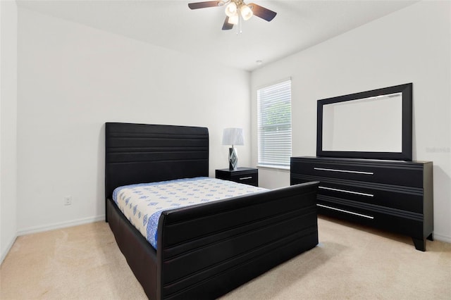 bedroom featuring ceiling fan and light colored carpet