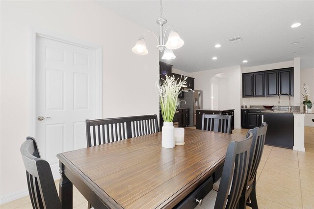 tiled dining area with a notable chandelier