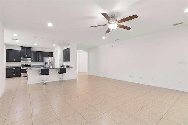 tiled living room featuring ceiling fan