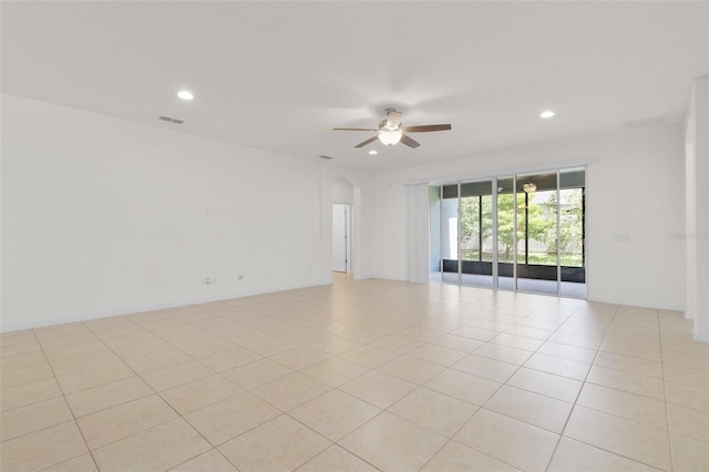 tiled empty room featuring ceiling fan