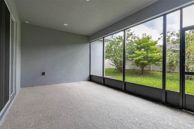 unfurnished sunroom featuring a wealth of natural light