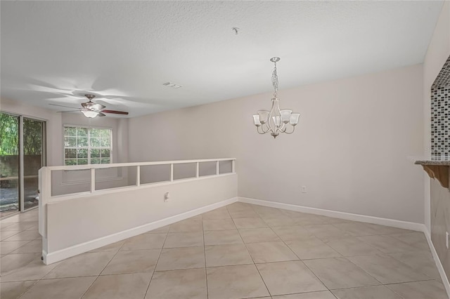 unfurnished room with ceiling fan with notable chandelier, a textured ceiling, and light tile patterned floors