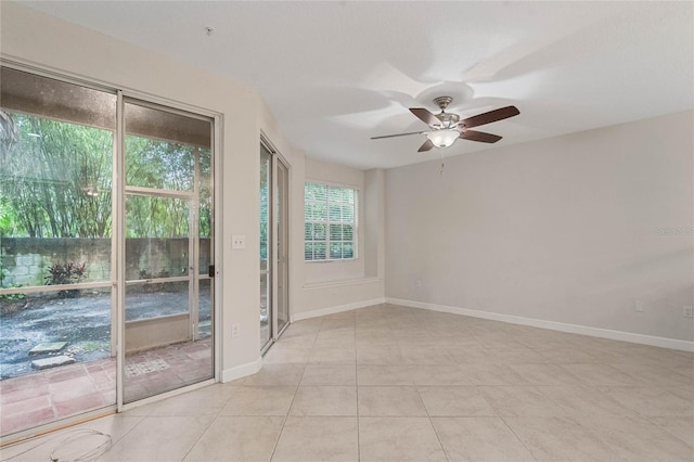 spare room featuring ceiling fan and light tile patterned floors