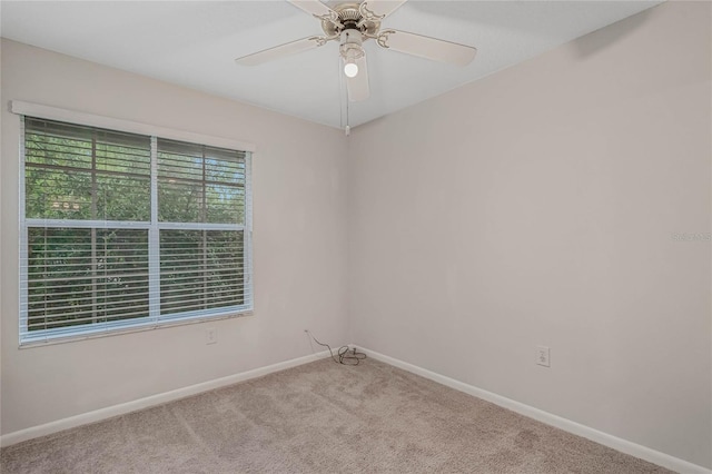 empty room featuring ceiling fan and light colored carpet