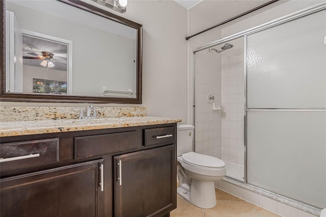 bathroom with an enclosed shower, tile patterned flooring, toilet, and vanity