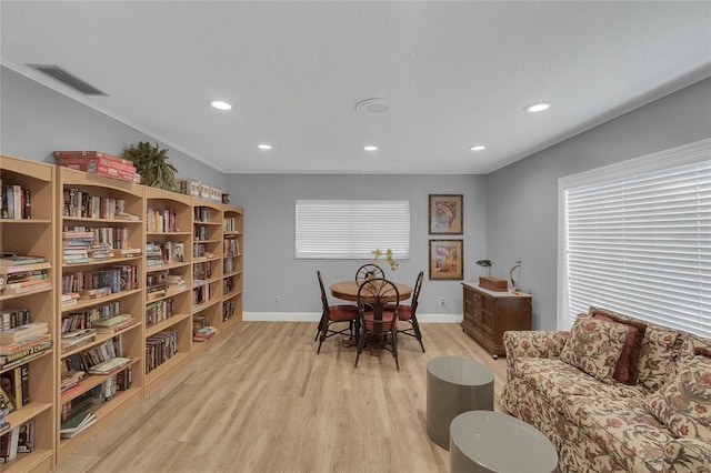 interior space with ornamental molding and light hardwood / wood-style floors