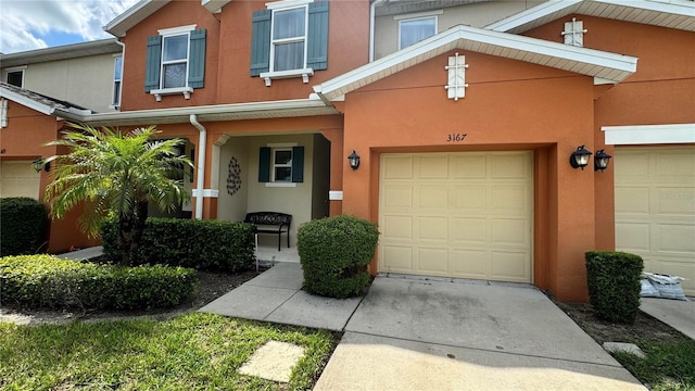 3167 Tocoa Cir, Kissimmee, FL 34746 - view of front of home featuring stucco siding, a garage, and concrete driveway