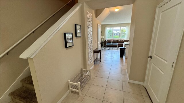 3167 Tocoa Cir, Kissimmee, FL 34746 - hall featuring light tile patterned flooring, stairs, and baseboards