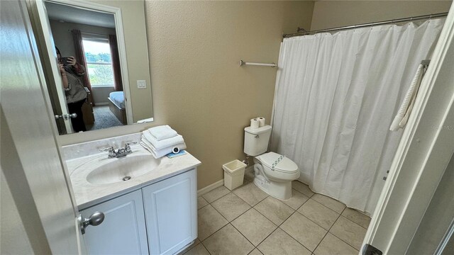 bathroom with tile patterned floors, a shower with curtain, vanity, and toilet